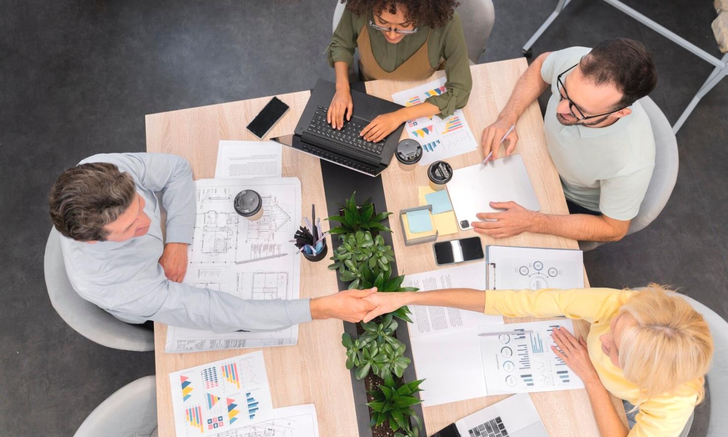 Business meeting discussing financial projections with charts and data visualization